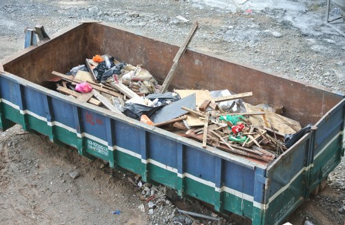 Vans parked during a flat clearance in Hounslow with sorted recyclables
